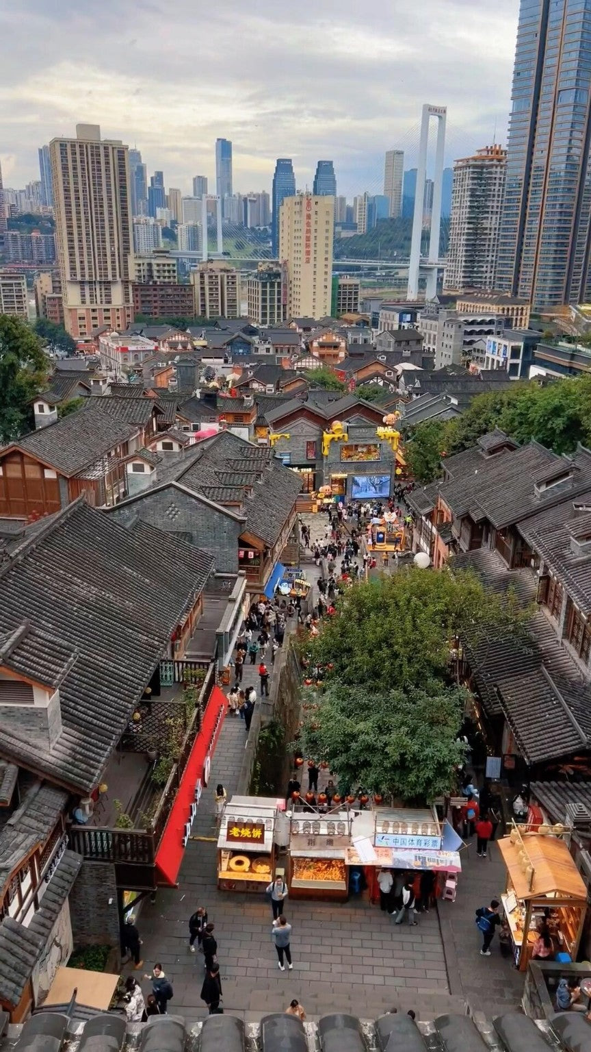 Traditional Chongqing hillside rooftops with modern skyline