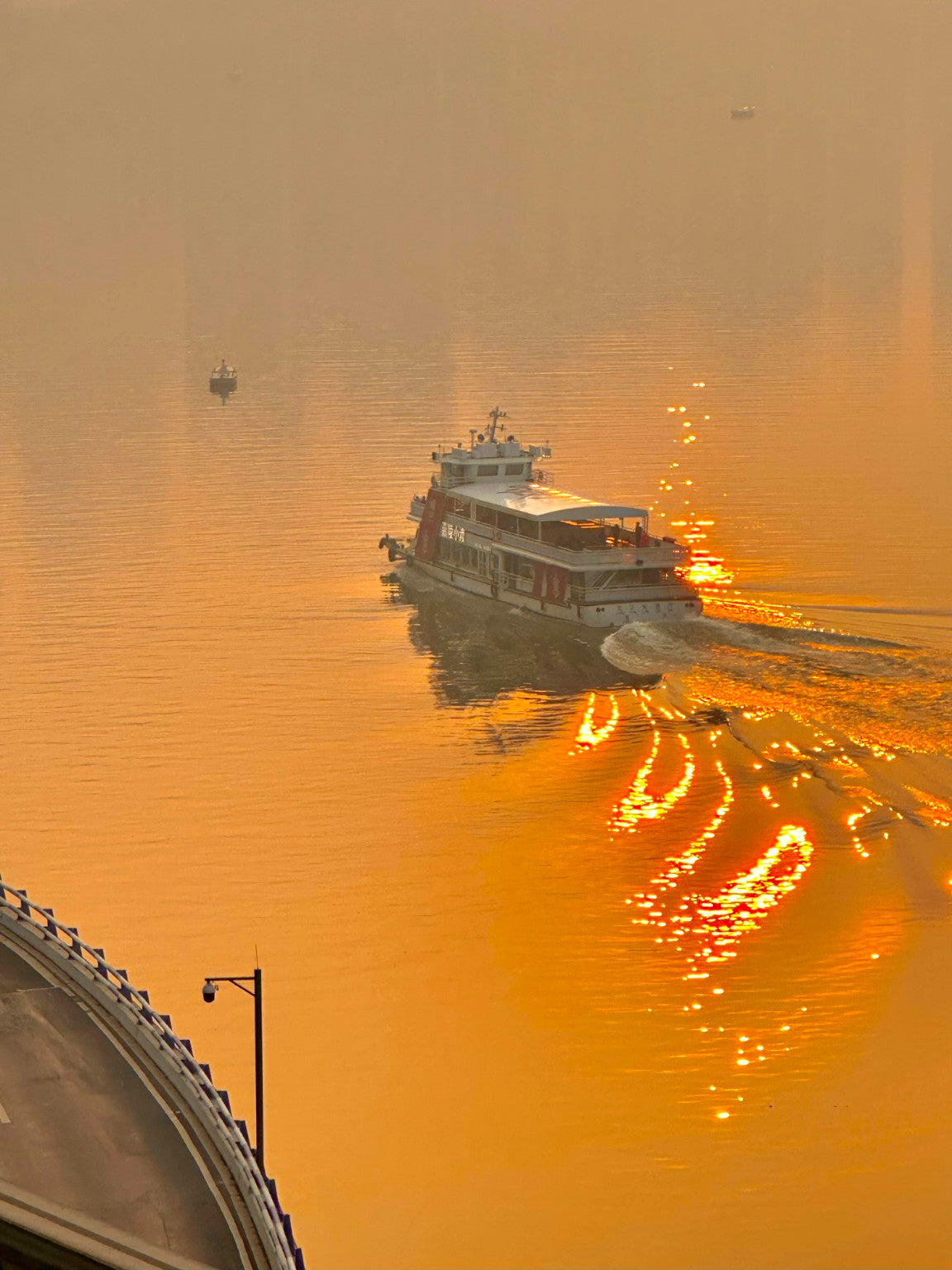 Passenger ferry cruising on the Yangtze River in Chongqing at sunset